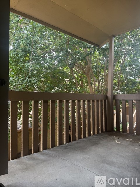 A balcony with a view of trees.
