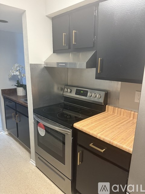 A kitchen with a stove and oven built into the cabinetry.