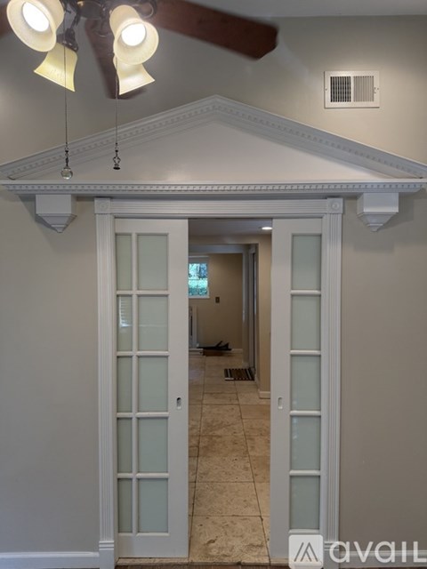 A white door with glass panels is open.