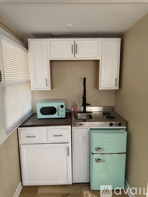 A kitchen with a white oven and a blue stove.