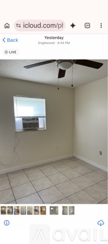 A room with a ceiling fan and a window.