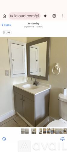 A bathroom with a sink, mirror, and toilet.