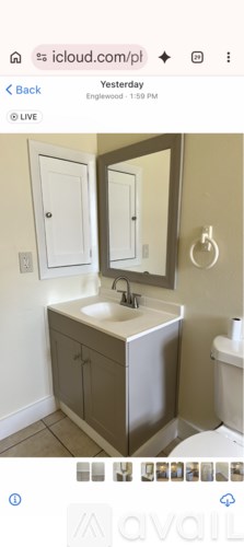 A bathroom with a sink, mirror, and toilet.