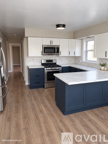 A kitchen with a white countertop and dark blue cabinets.