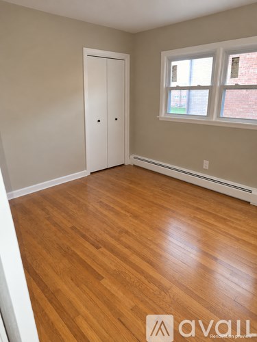 A room with wooden floors and a white door.