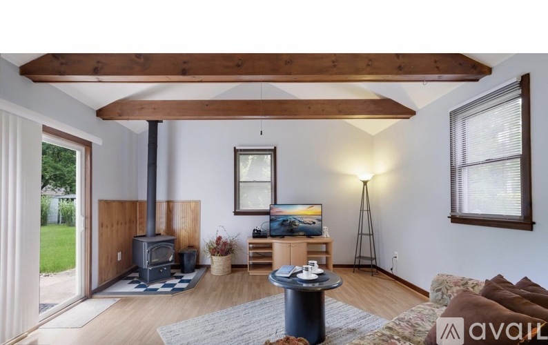 A living room with a wood stove and a television.