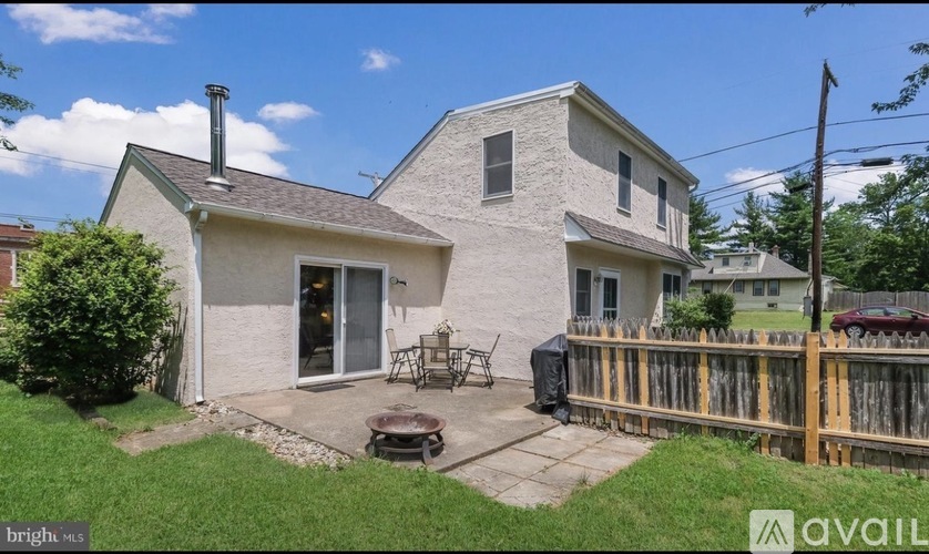 A house with a white exterior and a wooden fence.