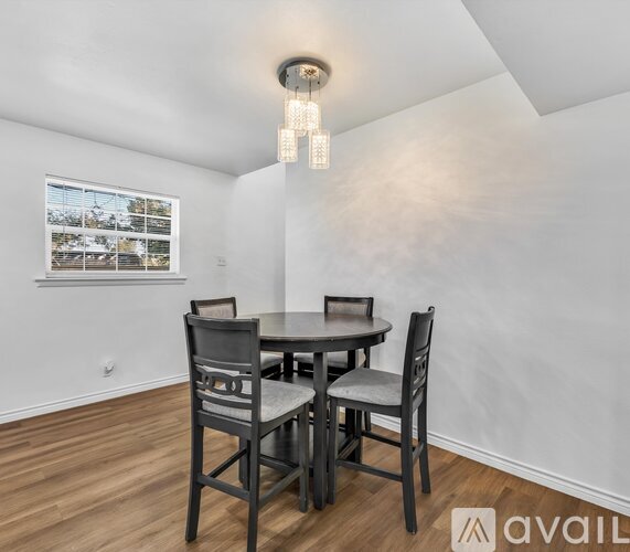A dining room with a table and chairs.
