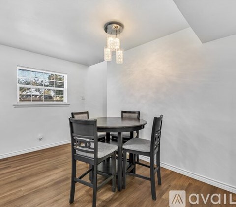 A dining room with a table and chairs.