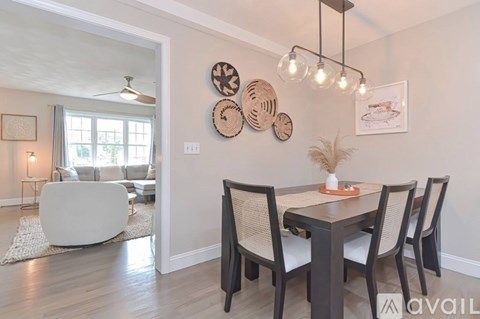 A modern dining room with a table set for four.