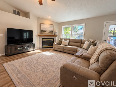 A living room with a large couch and a television.