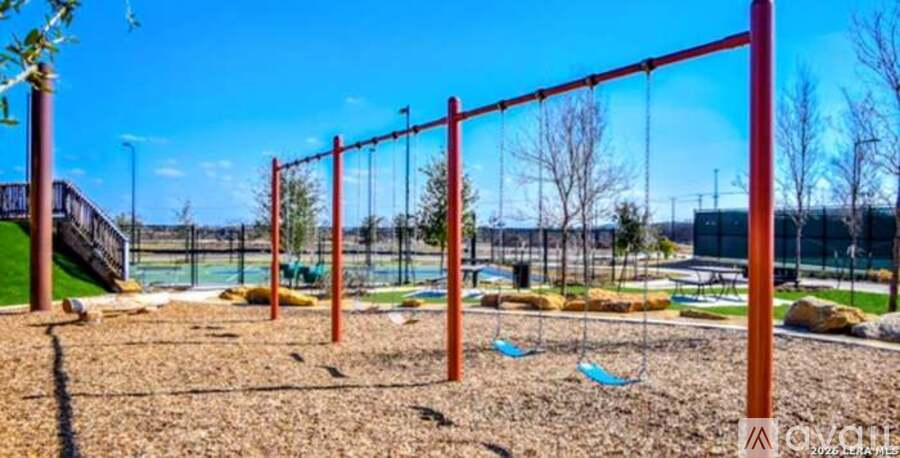 A playground with a swing set and a slide.