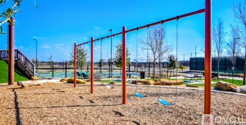 A playground with a swing set and a slide.