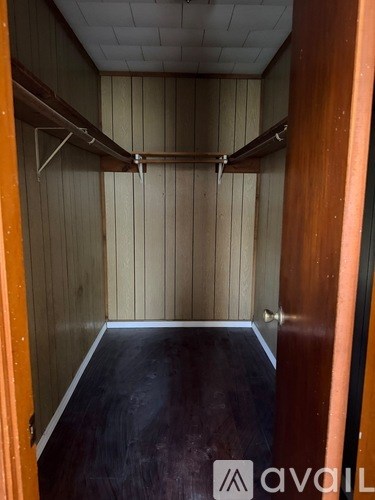 A room with wooden walls and a black floor.