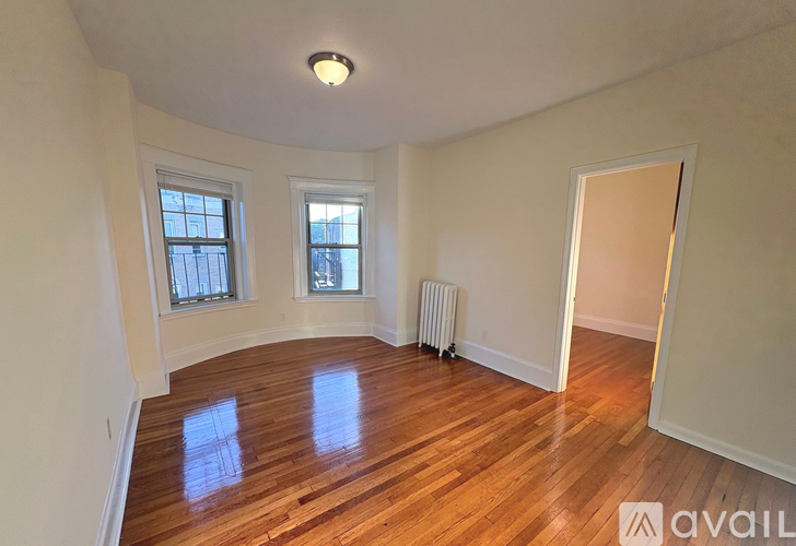 A room with wooden floors and a window.