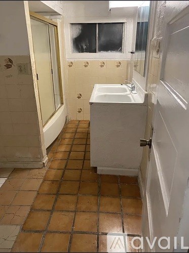 A bathroom with a sink and a shower.