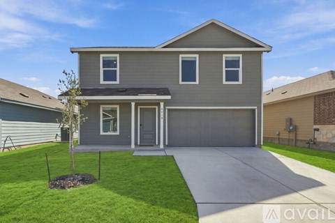 A house with a grey roof and a grey garage door.