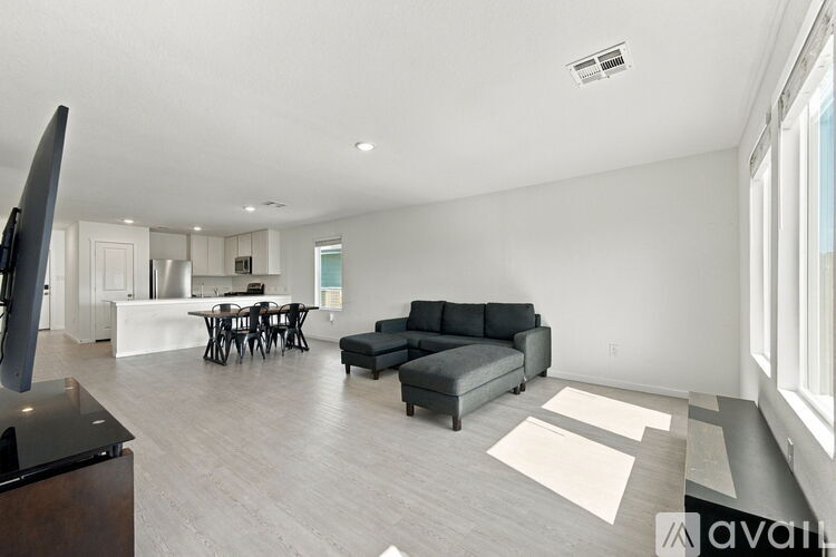 A living room with a grey couch and a television.