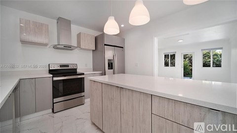 A modern kitchen with a stainless steel oven and a marble countertop.