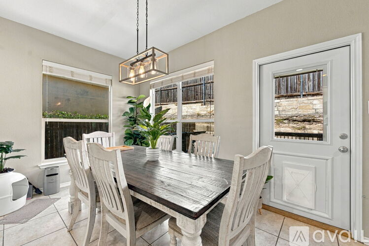 A dining room with a wooden table and chairs.