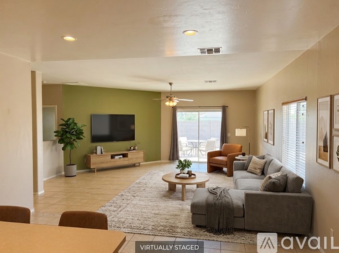 A living room with a grey couch and a wooden coffee table.
