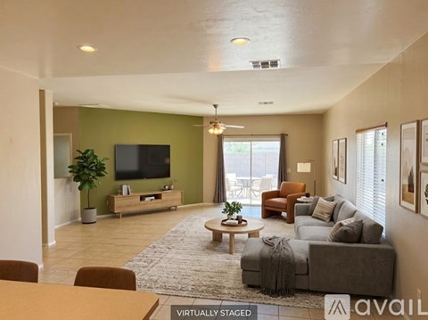 A living room with a grey couch and a wooden coffee table.