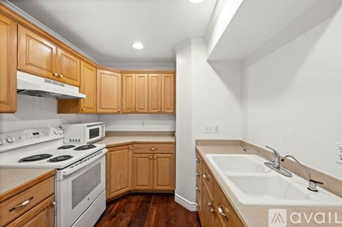 A kitchen with wooden cabinets and white appliances.