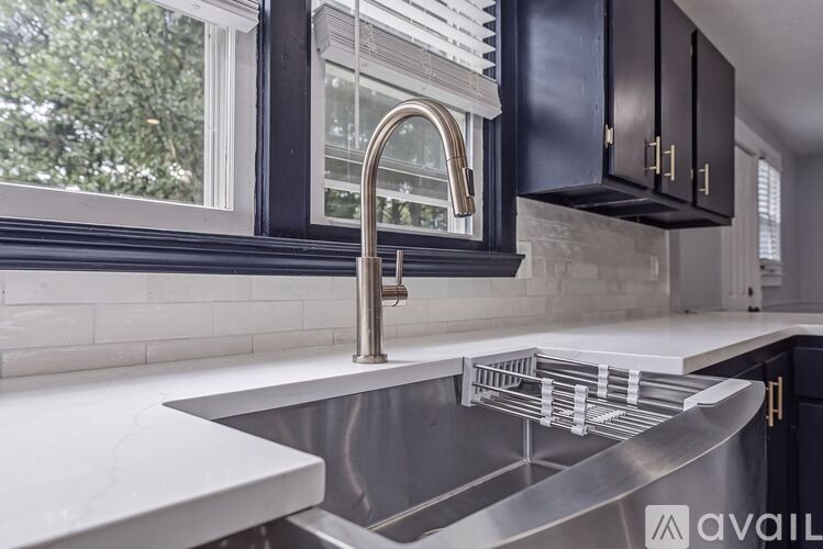 A kitchen with a sink and a window.