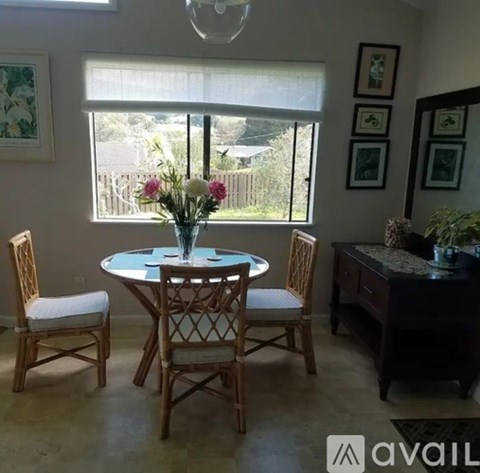 A dining room with a table and chairs.