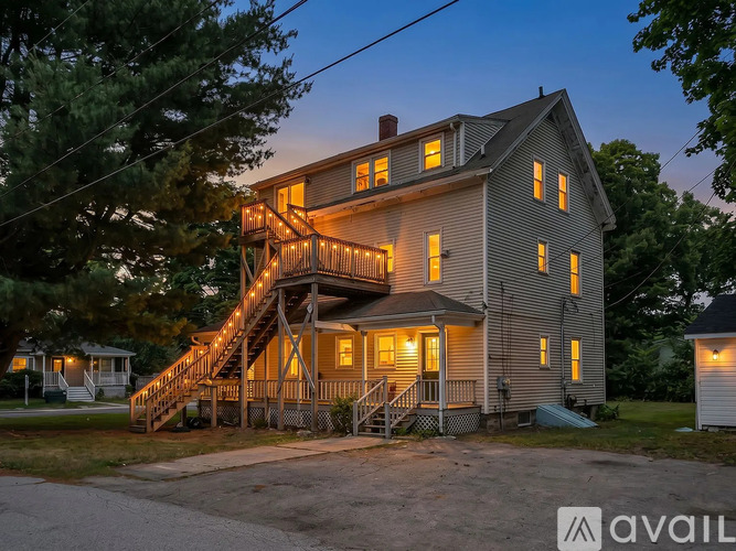 A house with a lit up staircase is available for rent.