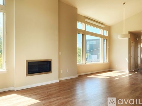 A living room with a fireplace and a television.