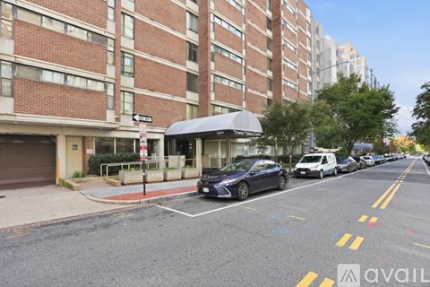 A street view with a car parked on the side of the road.