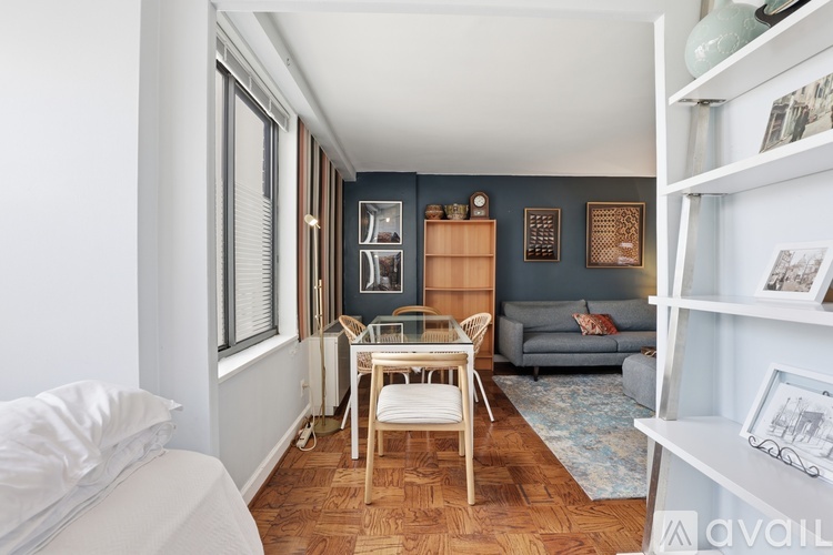 A living room with a grey couch and a wooden table.