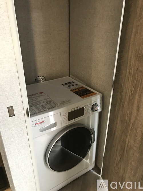 A white washing machine is in a small space.