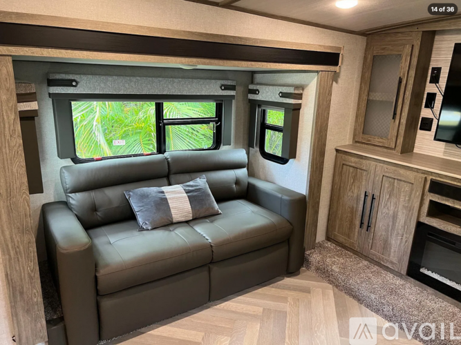 A living room with a couch and a window.