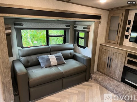 A living room with a couch and a window.