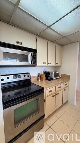 A kitchen with a stove, oven, and microwave.