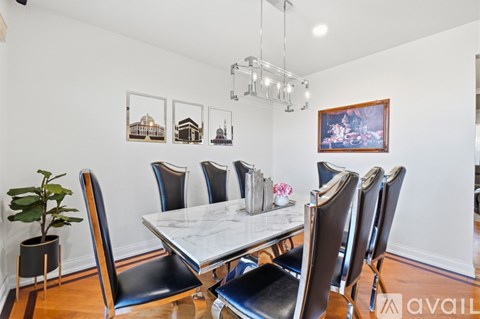 A dining room with a table and chairs.