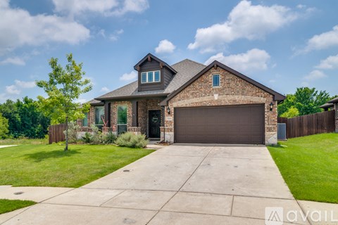 A house with a garage and a driveway in front.