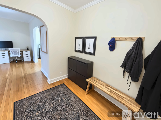 A room with a bench, a coat rack, and a black dresser.