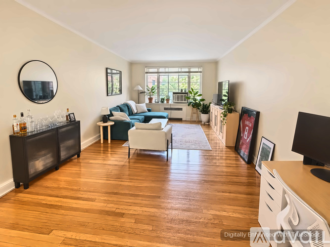 A living room with a blue sofa and wooden floors.