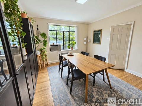 A kitchen with a table and chairs in the middle of the room.