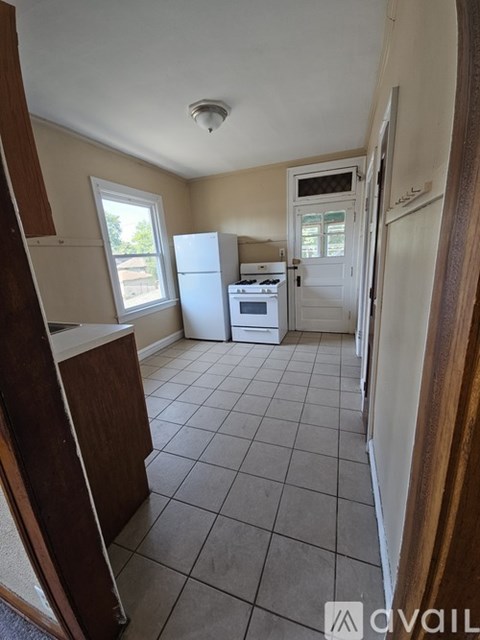 A kitchen with a white fridge and stove top oven.