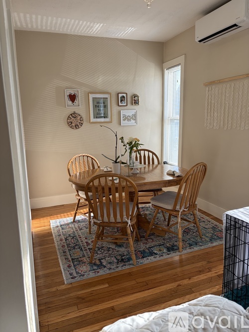 A dining room with a wooden table and chairs.