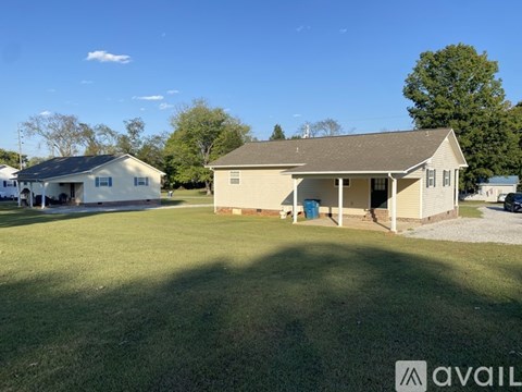 A house with a large lawn in front of it is for sale.