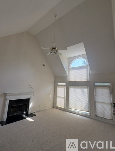 A living room with a fireplace and a window.