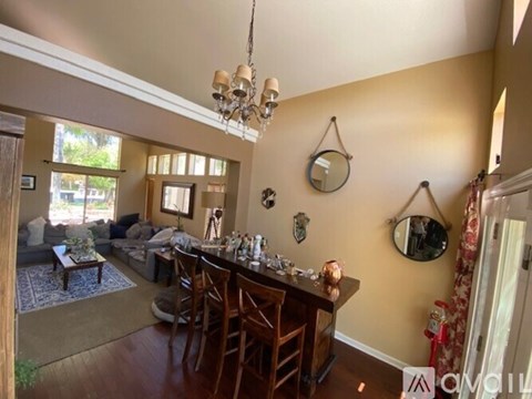 A dining room with a wooden table and chairs.