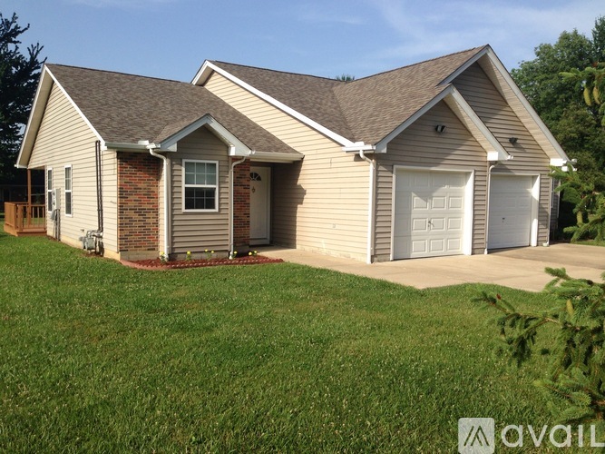 A house with a brown roof and a white garage door.