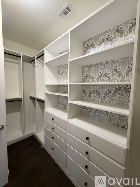 A white closet with drawers and shelves.