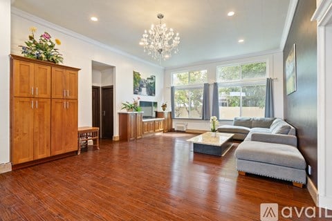 A living room with wooden floors and furniture.
